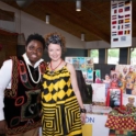 Alum Poses With Woman Both Wearing Traditional Clothing