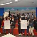 Group of students who participated in the event are holding posters highlighting different languages of the world