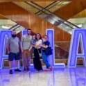 Ugur and host family in front a sign that reads "Dallas"