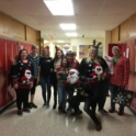 Students stand outside lockers wearing holiday outfits