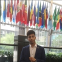 Youssef at the State Department in front of a lineup of flags
